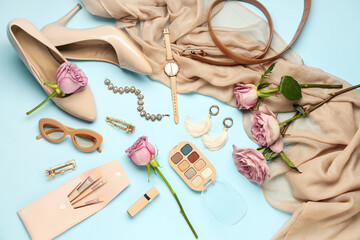 Composition with female accessories, cosmetics and beautiful rose flowers on color background