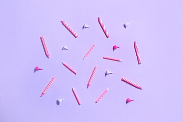 Pink birthday candles on lilac background