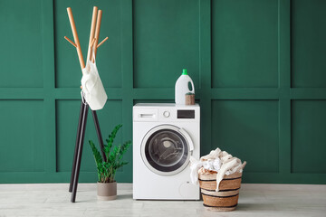 Interior of laundry room with washing machine, basket and rack