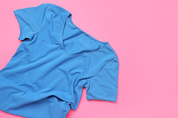 Crumpled blue t-shirt on pink background