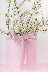 Fototapeta premium tree branches with blooming spring flowers in a pink gift box