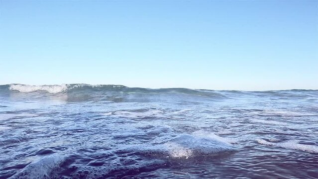 The breaking wave approaches and floods the screen. Oncoming sea wave slow motion. Underwater bubles Sea closeup