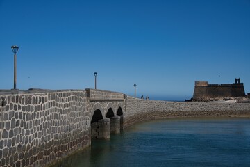 SAN GABRIEL CASTLE, ARRECIFE, LANZAROTE, SPAIN, APRIL 30, 2023: Panoramic view of the historic Castillo de San Gabriel, built in the 16th century, stands on a small rocky island in the city's harbor.