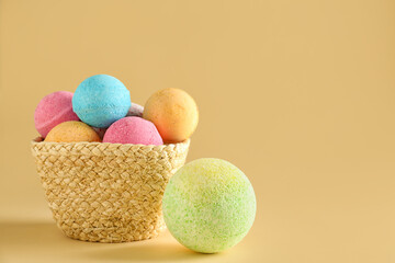 Basket with bath bombs on beige background
