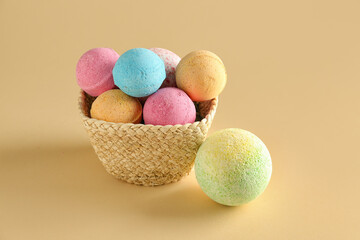 Basket with bath bombs on beige background