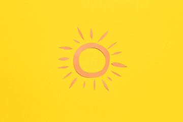 Paper sun on yellow background