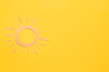 Paper sun on yellow background