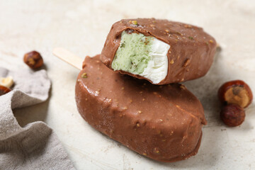 Tasty chocolate covered ice cream on light background, closeup