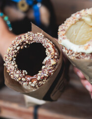 Trdelnik, traditional czech and european sweet street food, process of baking and cooking on street food festival market kiosk