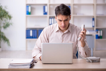 Young male employee working in the office