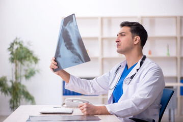 Young male doctor radiologist sitting in the clinic
