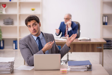 Two male colleagues sitting in the office