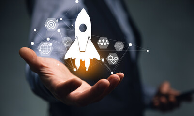 Startup concept. Businessman touching icon transparent rocket is launching