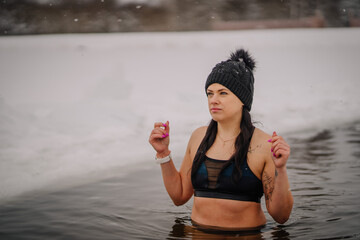 A woman is swimming in cold water during winter, winter cold water swims, healthy lifestyle
