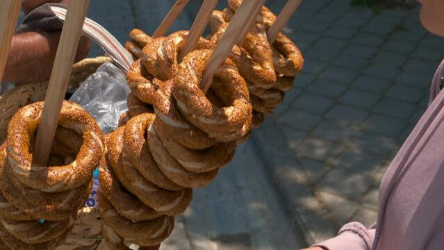 The female buys a bagel.. A view of child buy a bagel in the street in the day light. Generative AI