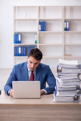 Young male employee working in the office