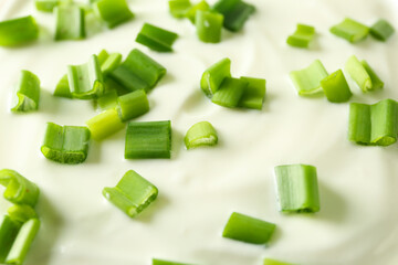 Sliced green onion on sour cream