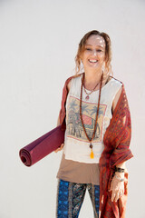 Yoga teacher with her yoga mat.  - 599082148