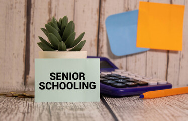 White card with the text Senior Schooling on study desk.