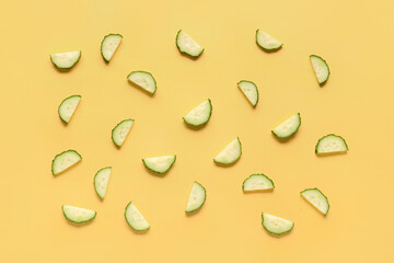 Slices of cucumber on yellow background