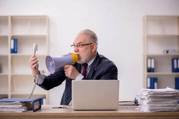 Old boss employee holding magaphone at workplace