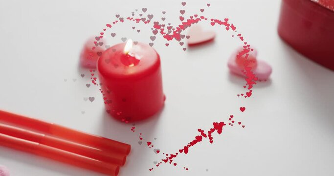Animation of hearts over candles on white background