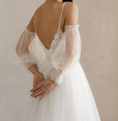 Gorgeous long wedding backless dress. Bride in the shoulderless white wedding dress with fancy...
