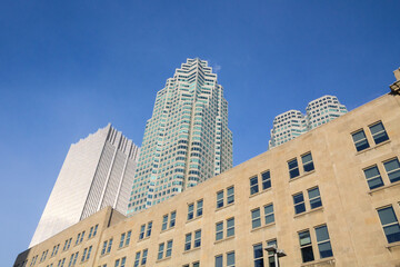 Obraz premium Skyscrapers of various sizes and ages (from the 30's till the 2000's) in downtown Torono, Ontario, Canada during a sunny winter afternoon