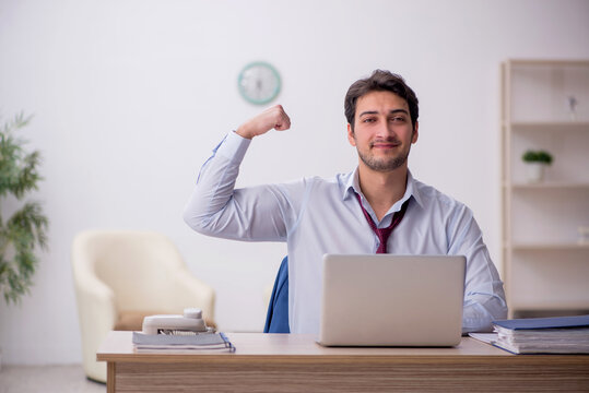 Young male employee working in the office