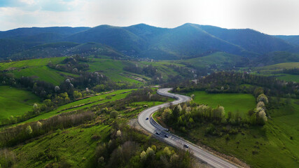 Fototapeta na wymiar Curved road, Apuseni mountains, Romania. Top aerial photography.