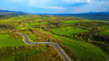 Curved road, Apuseni mountains, Romania. Top aerial photography.