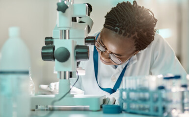 Testing the hypotheses through experiments and observations. a young scientist using a microscope...
