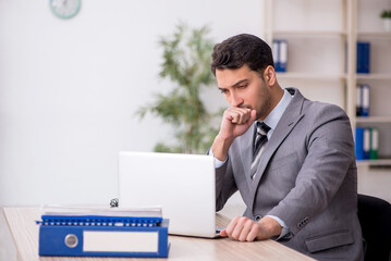 Young male employee working in the office