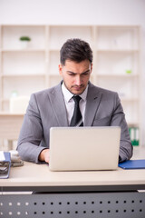 Young male employee working in the office