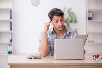 Young male employee working in the office