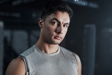 Start every workout with a warrior mindset. Portrait of a confident young man at a gym.