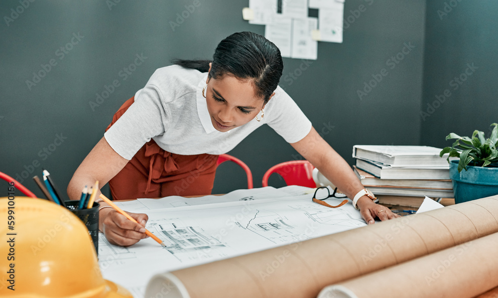 Aufkleber shes busy producing master designs. a young architect working with blueprints in an office.