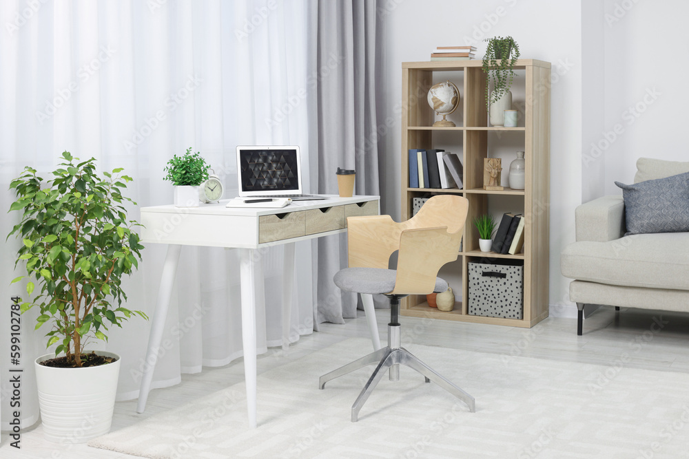 Poster Workplace with modern laptop on desk and comfortable chair at home