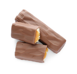 Pieces of chocolate bars with caramel on white background, top view