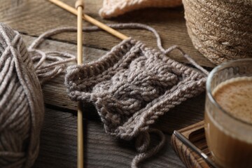 Fototapeta na wymiar Soft grey woolen yarn, knitting and needles on wooden table, closeup