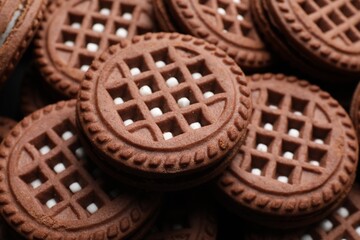 Tasty chocolate sandwich cookies with cream as background, closeup