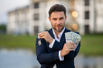 House owner, real estate agents hold money dollars and house keys. Housing estates, buying and...