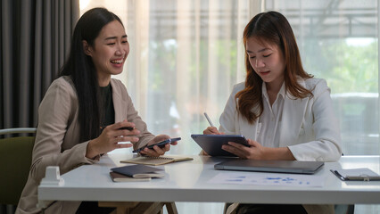 Happy young entrepreneurs discussing marketing plan in modern office or coworking space