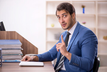 Young male employee working in the office