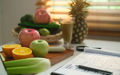 Diet plan paper and fresh vegetables and fruits on white table. Dieting, healthy lifestyle and...