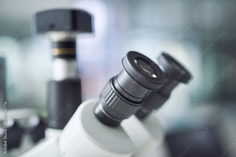 Poster you cant escape my eyes. a microscope in a modern laboratory.