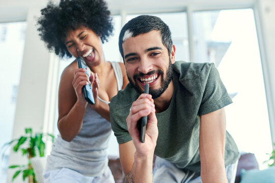 We learned how to entertain ourselves while staying in. a couple having a sing along at home.