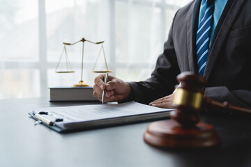 Young lawyer or legal advisor is reading and carefully checking the validity of documents and investment agreements for signing contracts managing justice concepts.