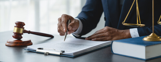 Young lawyer or legal advisor is reading and carefully checking the validity of documents and investment agreements for signing contracts managing justice concepts.