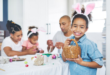 I am only passionately curious. a mother and father painting eggs with their daughter at home.